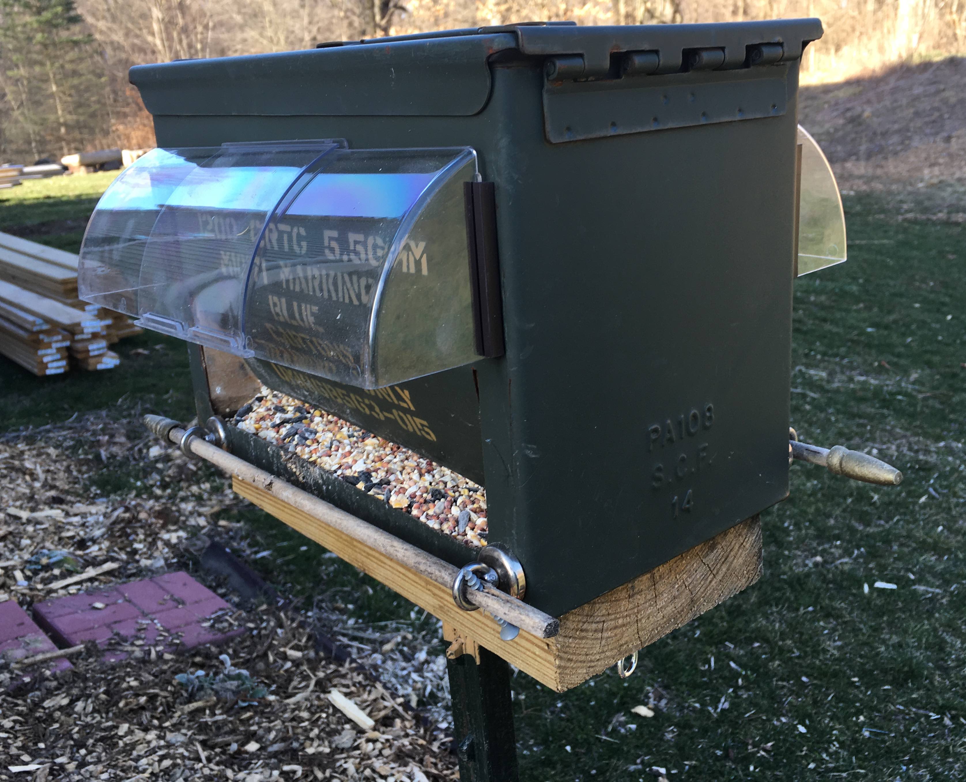 ammo box bird feeder with adjustable heat deflector